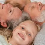A joyful multigenerational family lying together and smiling, illustrating love and togetherness.
